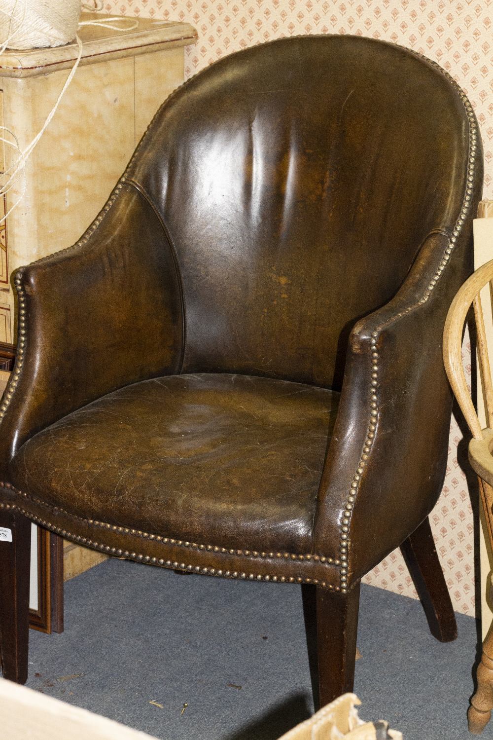 A BROWN LEATHER TUB CHAIR with square tapering legs, 60cm wide x 96cm high