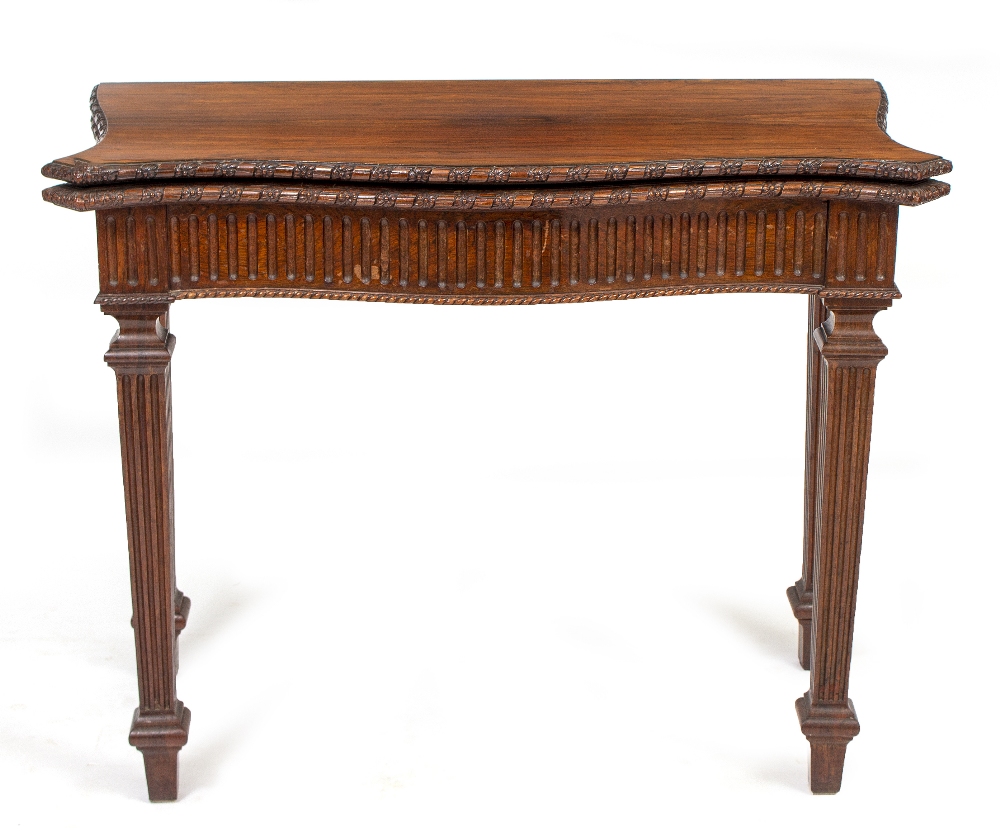 A 19TH CENTURY GEORGIAN STYLE ROSEWOOD SERPENTINE FOLD OVER CARD TABLE with fluted frieze and square