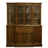 A ROSEWOOD BREAKFRONT SECRETAIRE BOOKCASE with four glazed doors opening to reveal adjustable