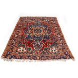 AN OLD BLUE GROUND ORIENTAL RUG with central medallion and a triple banded border, 191cm x 150cm