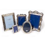 A CARRS SILVER PHOTOFRAME 22cm x 17.5cm; an oval silver photoframe, 16.5cm x 12.5cm and three silver