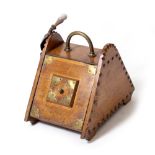 A LATE VICTORIAN OAK COAL BOX with brass mount and shovel, 35cm x 52cm x 43cm