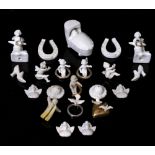 A COLLECTION OF GERMAN CERAMIC CAKE DECORATIONS to include a child in a crib, horseshoes, a skier,