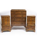 A PAIR OF REPRODUCTION YEW WOOD VENEERED BEDSIDE CHESTS each with eight small drawers with brass