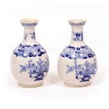 A PAIR OF LATE 18TH / EARLY 19TH CENTURY BLUE AND WHITE DELFT WARE BOTTLE VASES decorated with vases