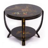 A CIRCULAR BLACK LACQUERED TWO TIER TABLE 48cm high