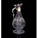 AN EARLY 20TH CENTURY CLARET JUG with lion head scroll handle and body decoratively engraved with