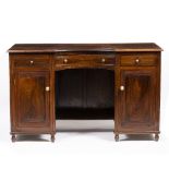 A ROSEWOOD KNEEHOLE DESK with three frieze drawers, two panelled doors and raised on turned feet,