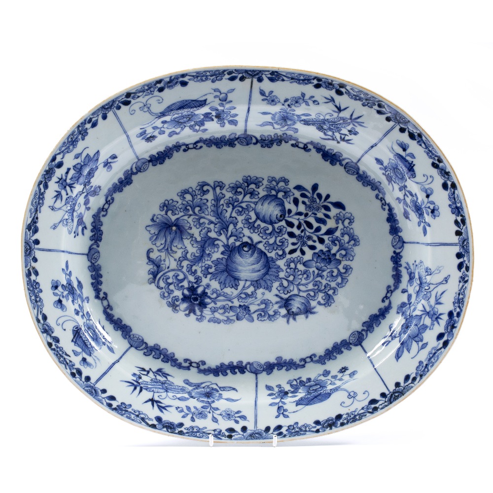 Oval blue and white dish Chinese, 18th Century decorated with a central panel depicting flowers, the