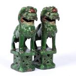Pair of temple dogs Chinese, 19th Century the standing green glazed figures with mouths slightly