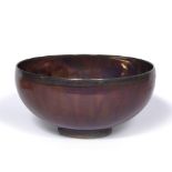 Sutton Taylor (British 1943) Large ceramic bowl deep red and black lustre glaze moulded potter's