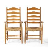 Cotswold School Pair of ash armchairs ladder-back, rush seats and turned supports and legs each