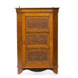 Manner of Simpson of Kendal Oak corner cupboard panels carved with flowers and fruits, finished with