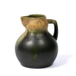 In the style of Christopher Dresser Stoneware jug mottled deep green and brown glaze "586" stamped