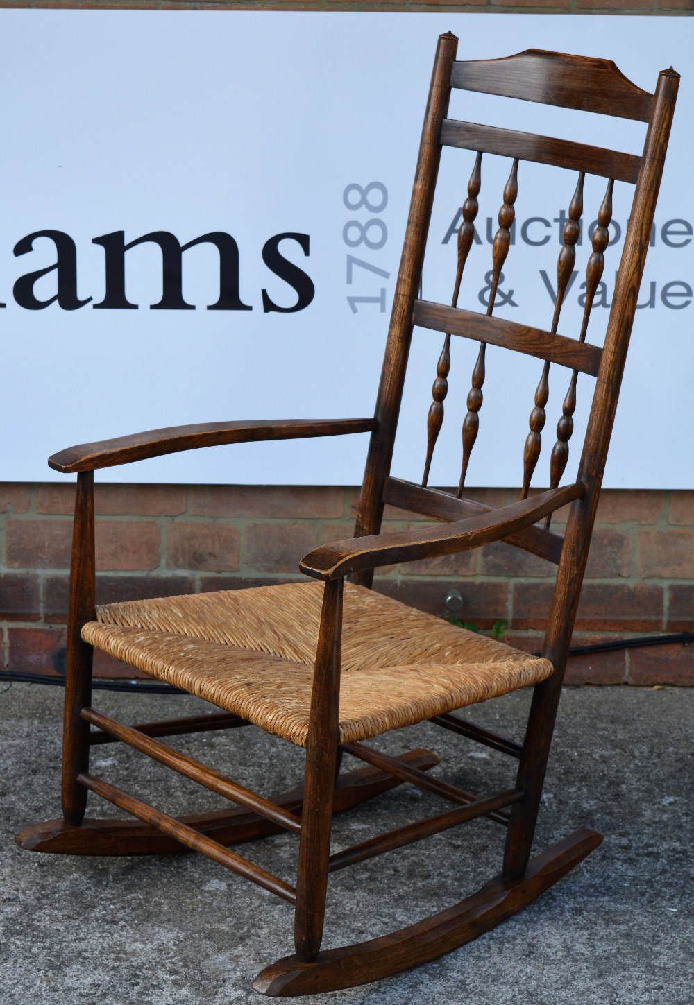 Neville Neal Ash rocking chair, circa 1960 ladder-back with stylised supports, rush seat stamped