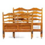 Attributed to Hugh Birkett (1919-2002) Walnut bed frame stylised supports, finished with carved