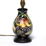 Moorcroft Pottery Lamp base tube lined decoration, wooden base factory marks to underside 28cm high