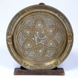 Cairoware dish Eqypt, 20th Century engraved with silvered metal depicting calligraphy 34cm across