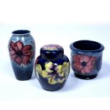 Three pieces of Moorcroft Pottery Anenome pattern vase and flower pot and a Hibiscus pattern