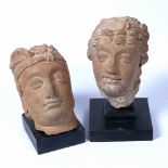 Two Roman type terracotta heads each on a later stand, 17cm and 14cm