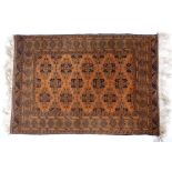Afghan rust ground rug with central panel of stylised designs 175cm x 119cm approx.