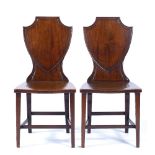 Pair of mahogany hall chairs George III, each with a shield back, 105cm high