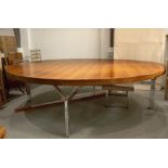 Gordon Russell Large rosewood table, 1970, veneered, chrome legs, 244cm diameter Licence number: