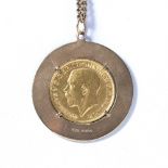 King George V 1911 sovereign in a 9ct yellow gold pendant mount on a gilt metal chain, 24 grams