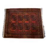 Afghan rust ground rug with central elephant foot medallions 148cm x 177cm