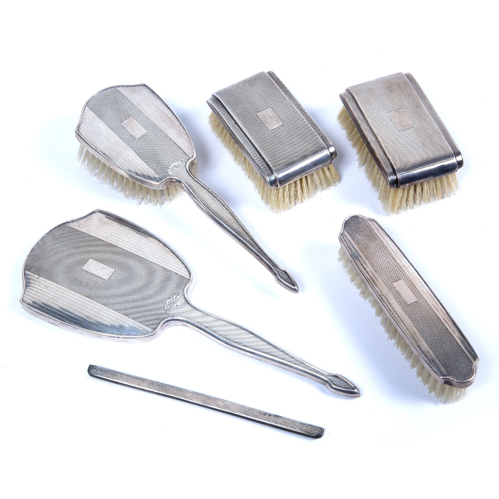 Silver mounted dressing table set consisting of brushes and a hand held mirror (6)