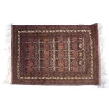 Afghan rust ground rug with central panel of medallions 128cm x 180cm approx.