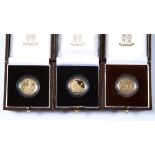 Three Britannia UK Royal Mint proof quarter ounce gold coins with ephemera and boxed