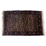 Afghan gold ground rug with central motifs 110cm x 181cm approx.