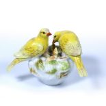 Meissen model of two canaries circa 1890, the bird on a nest with young, crossed swords mark, 9.