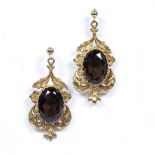 Pair of 9ct yellow gold earrings with scrolling leaves and floral decoration with faceted brown
