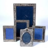 Collection of five silver and white metal photo frames in various sizes and styles