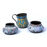 Three Qajar style enamels Turkey, 20th Century consisting of two bowls decorated with flowers and