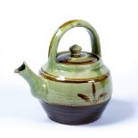 Winchcombe pottery teapot and cover probably 1930s, slip decoration on pale green glaze, impressed