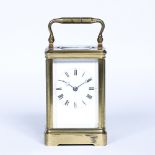 Brass cased carriage clock with loop handle and Roman numerals, with key, 7cm wide x 7cm deep x 12cm