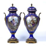 Pair of Sevres porcelain vases French, 19th Century with gilt and hand painted decoration on a