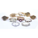 Collection of gold and yellow metal rings including two wedding bands stamped 14k, an opal ring, 9ct