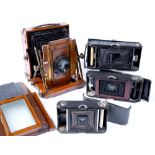 Aldis Anastigmat wooden plate camera on bellows, a Kodak pocket folding camera, an Ensign folding