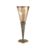 A SILVER AND SILVER GILT GOBLET, with plain conical bowl, and textured stem and foot, by Stuart