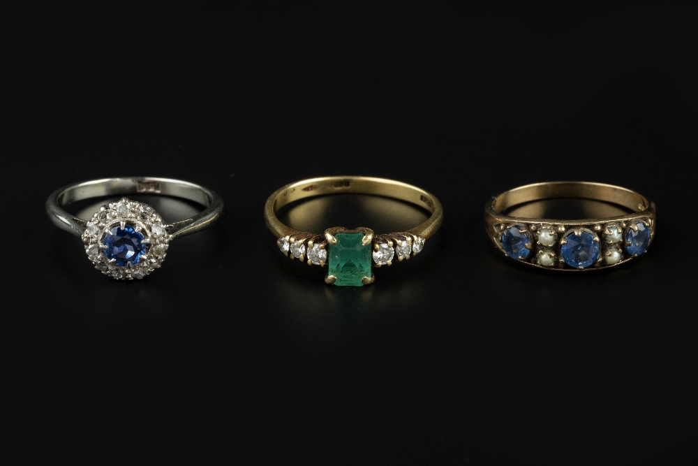 THREE GEM SET DRESS RINGS, comprising an emerald and diamond seven stone ring, 18ct gold mounted,