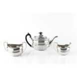 AN EDWARDIAN SILVER THREE PIECE TEA SERVICE, of Georgian design, having shaped oval bodies with