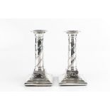A PAIR OF GEORGE III SILVER CANDLESTICKS, with reeded drip pans, the cylindrical columns embossed