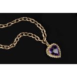 AN AMETHYST AND HALF PEARL PENDANT ON CHAIN, the heart-shaped mixed-cut amethyst bordered by half