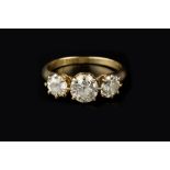 A DIAMOND THREE STONE RING, the graduated round brilliant-cut diamonds in claw setting, 18ct gold