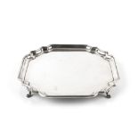 A SILVER SMALL SALVER, with shaped, squared border, on pad feet, by Barker Brothers Silver Ltd,