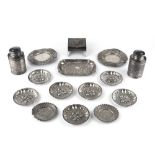A COLLECTION OF INDIAN WHITE METAL PIECES COMPRISING a pair of cylindrical canisters and covers, a